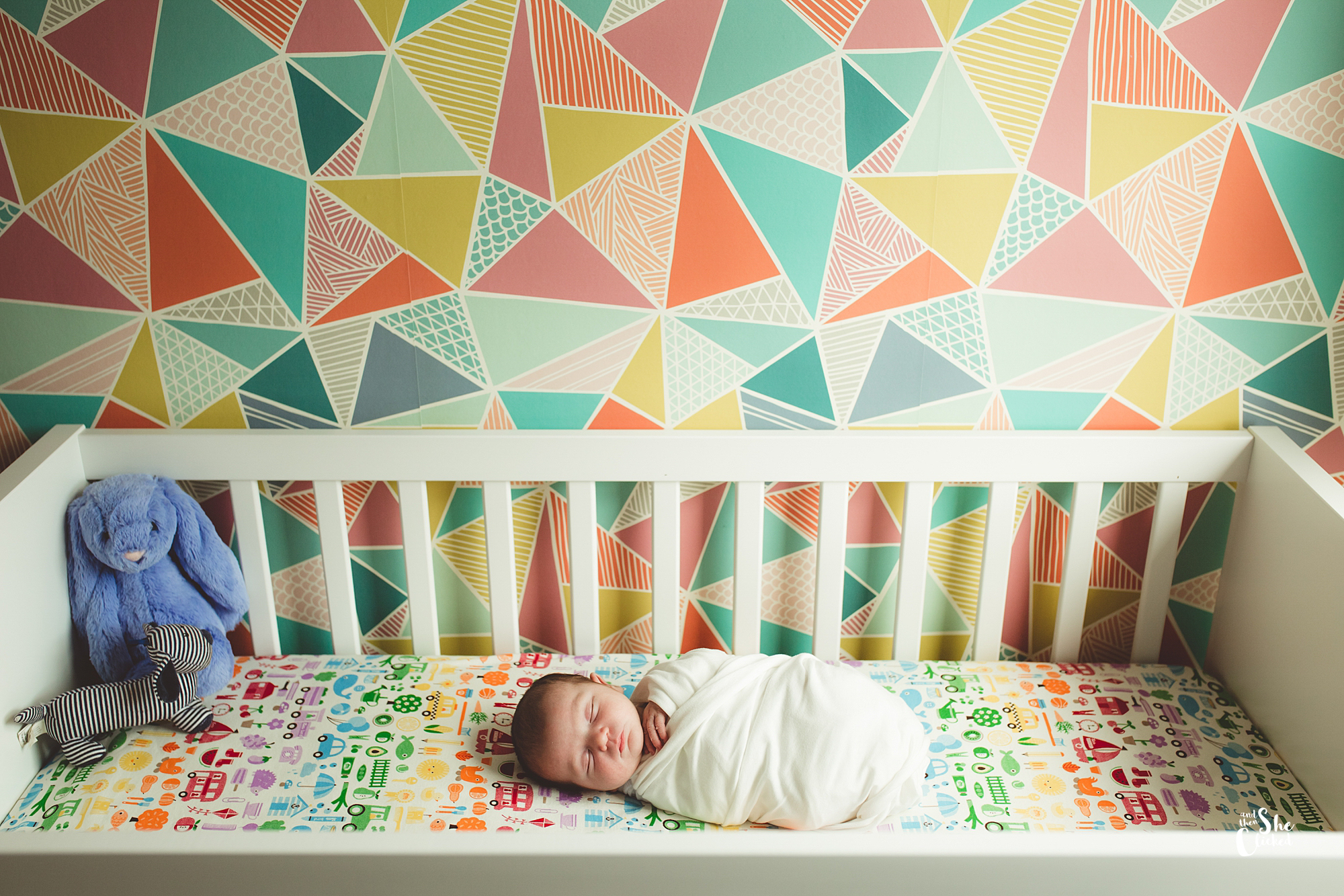 Nursery newborn photoshoot in cot colourful